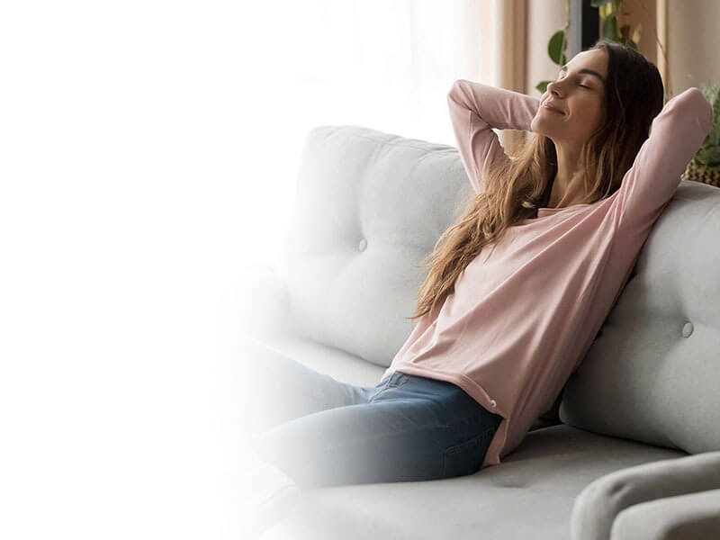 Lady sitting on a couch relaxed