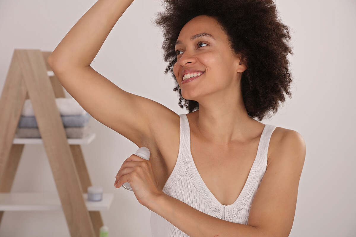 CBD deodorant-woman putting on deodorant.