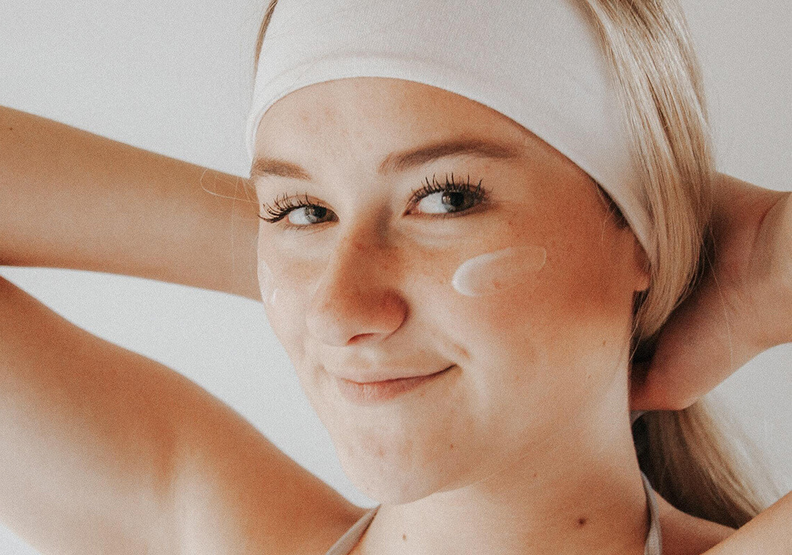 girl using CBD skincare cream