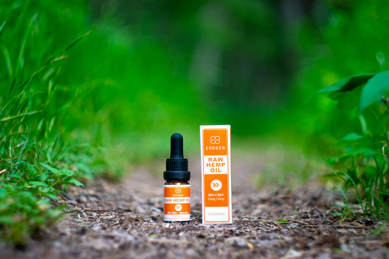 30% CBD drops on ground with grass on the side