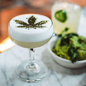 CBD cocktail with white foam and green leaf