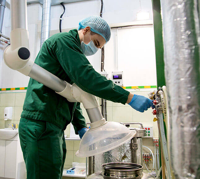 Worker in green suit operating machinery