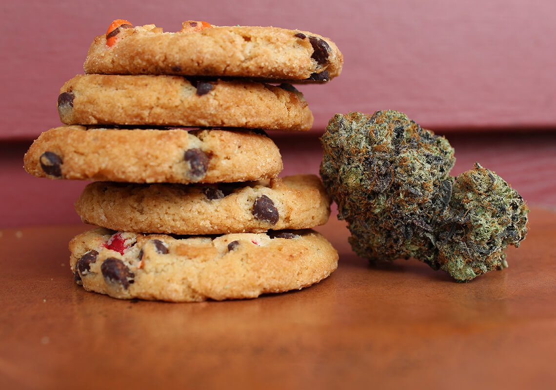 stack of cookies next to hemp bud