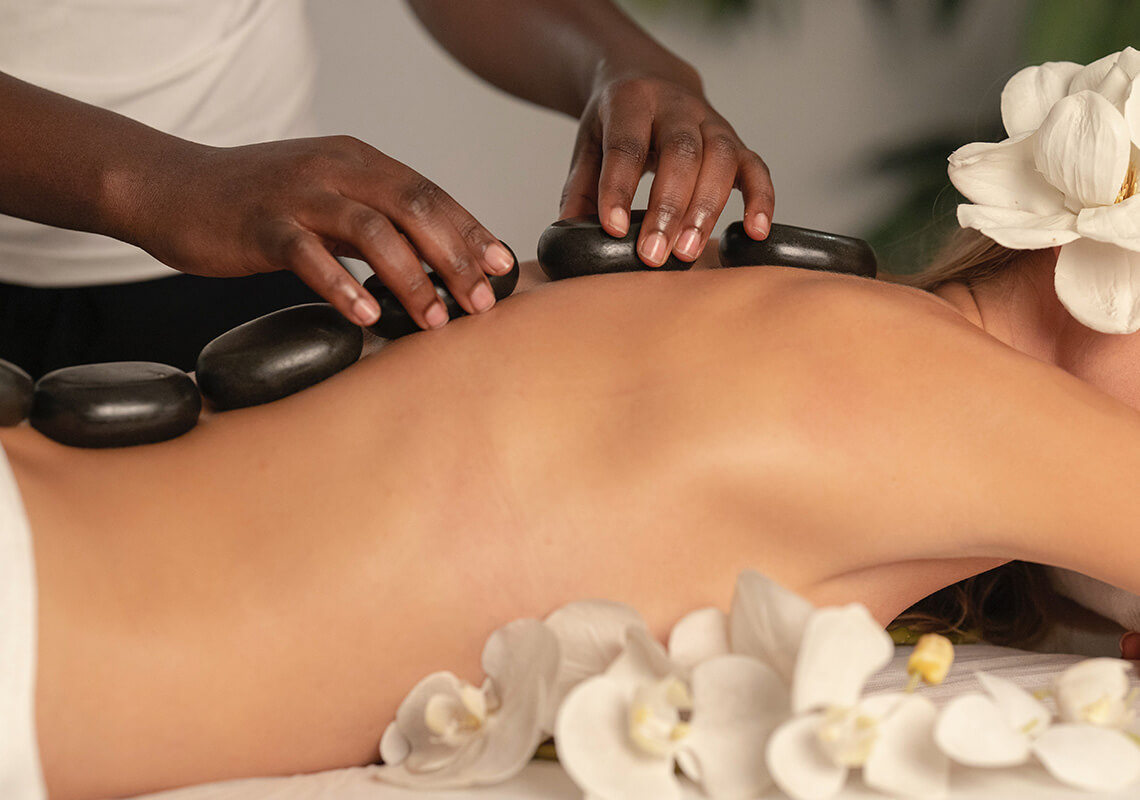 woman receiving hot stone massage