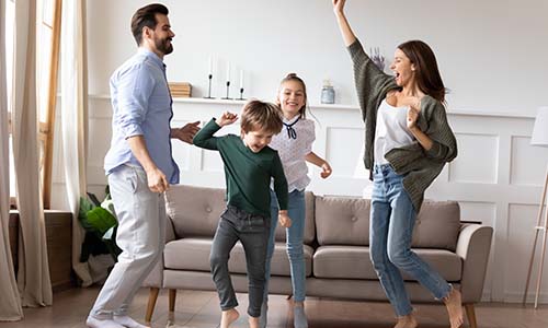Family jumping having fun in their living room