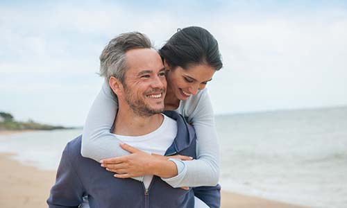 Two people standing on a beach