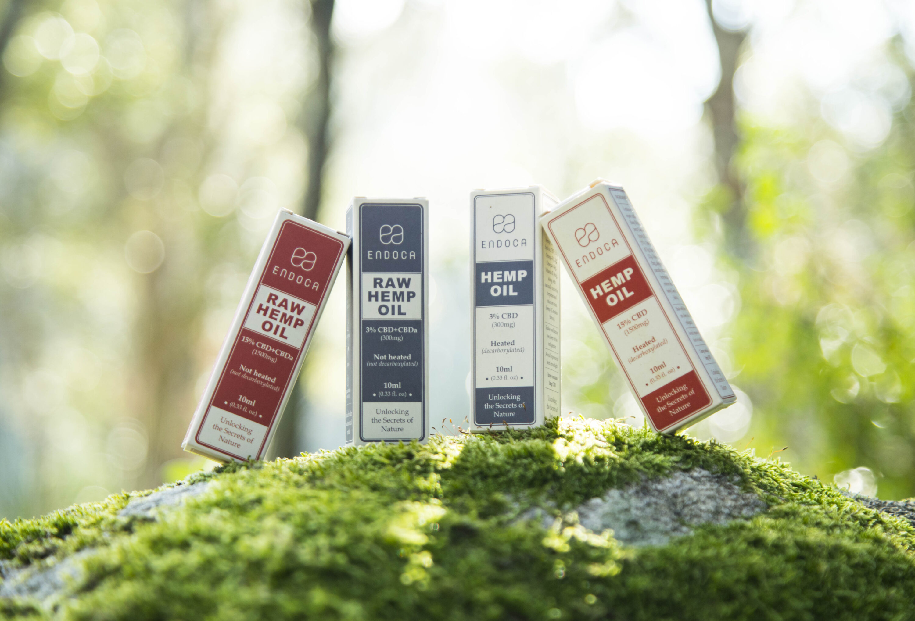 Endoca Hemp Oil and Raw Hemp Oil product boxes arranged on green forest moss
