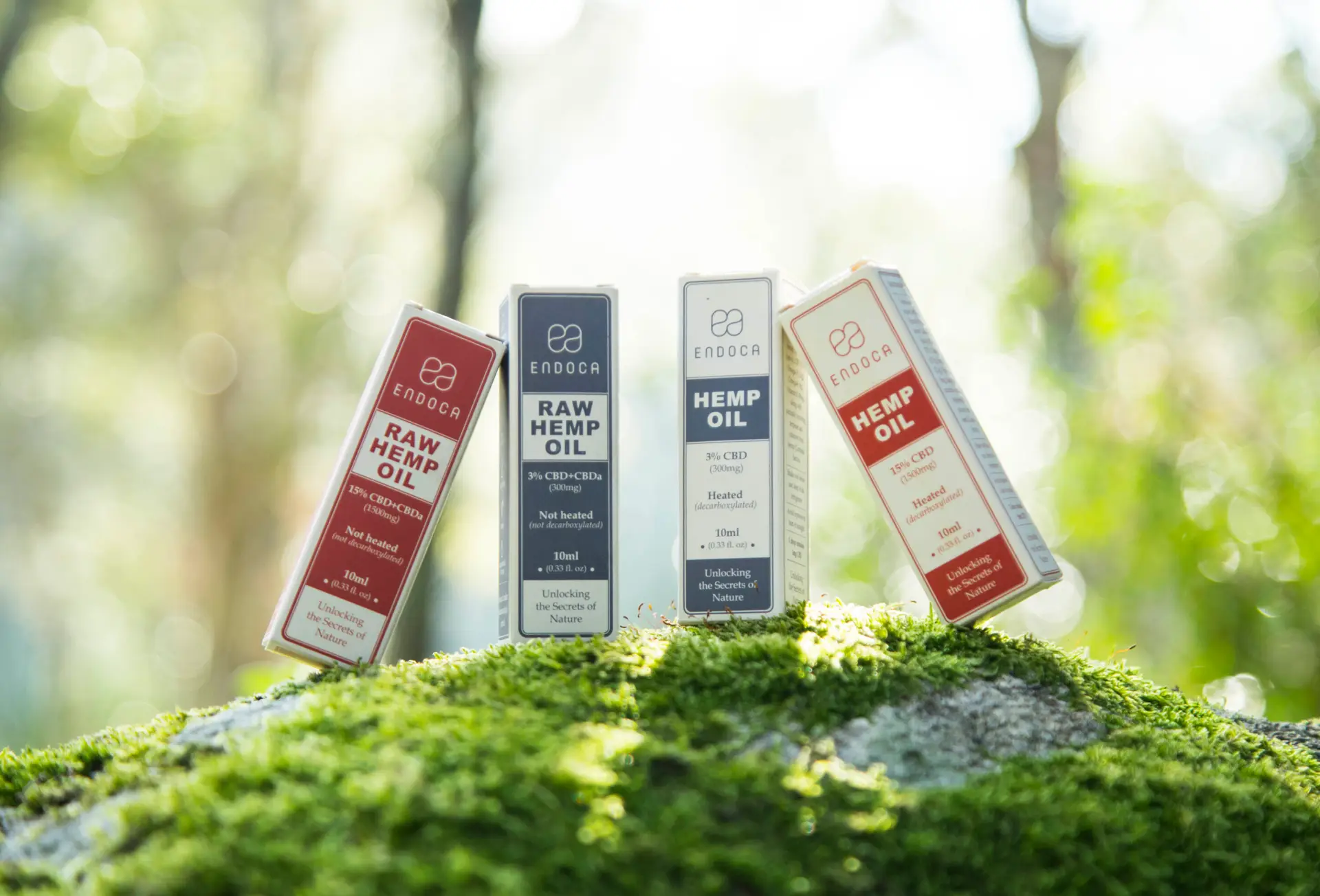 Endoca Hemp Oil and Raw Hemp Oil product boxes arranged on green forest moss
